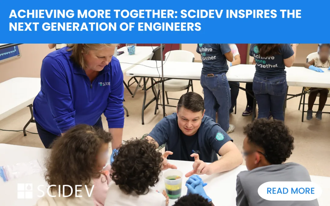 SciDev employees preforming STEM experiment with children at Salvation Army Red Shield youth Center.